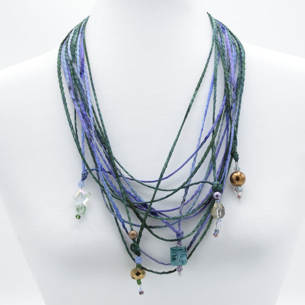 artisan hand crafted long necklace with 14 cords hand sewn from cotton batik fabric adorned with crystals and beads