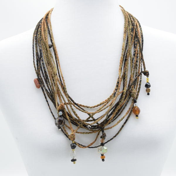 artisan hand crafted long necklace with 14 cords hand sewn from cotton batik fabric adorned with crystals and beads