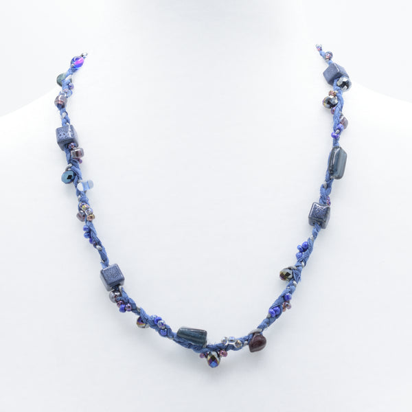 artisan hand crafted crafted mid length necklace of hand sewn batik cords braided cotton cords and embellished with crystals and beads
