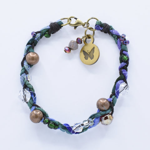 artisan crafted bracelet with hand sewn cords from cotton batik fabric braided with cotton cords embellished with crystals and beads 