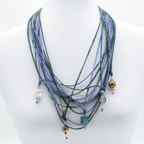 artisan hand crafted long necklace with 14 cords hand sewn from cotton batik fabric adorned with crystals and beads 