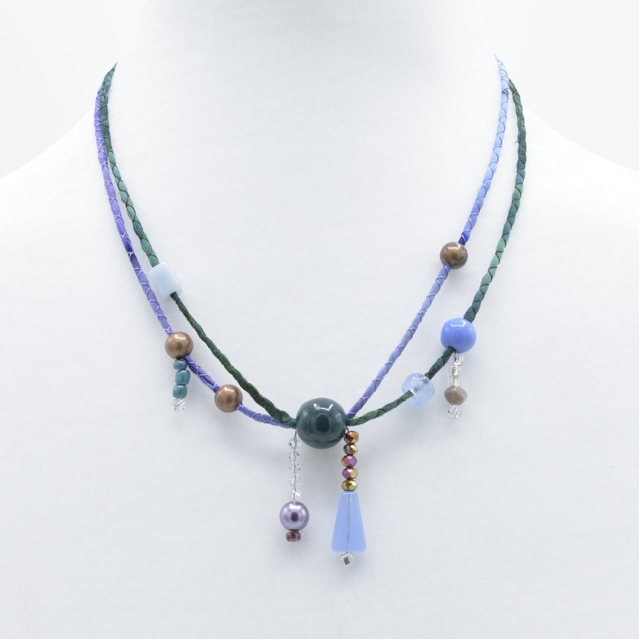 artisan hand crafted short necklace with hand sewn cords from cotton batik fabric embellished with crystals and beads 