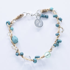 artisan crafted bracelet of cotton cords braided and embellished with crystals and beads 