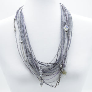 artisan hand crafted long necklace with 14 cords sewn from cotton batik fabric adorned with chain, crystals and beads 