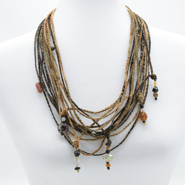 artisan hand crafted long necklace with 14 cords hand sewn from cotton batik fabric adorned with crystals and beads 