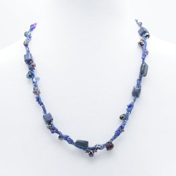 artisan hand crafted crafted mid length necklace of hand sewn batik cords braided cotton cords and embellished with crystals and beads 